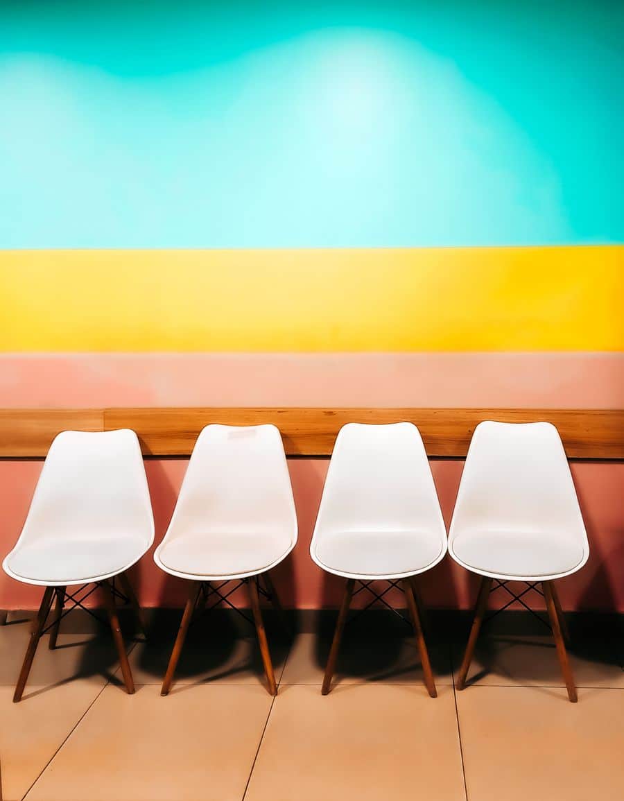 An empty clinic waiting room with a row of chairs