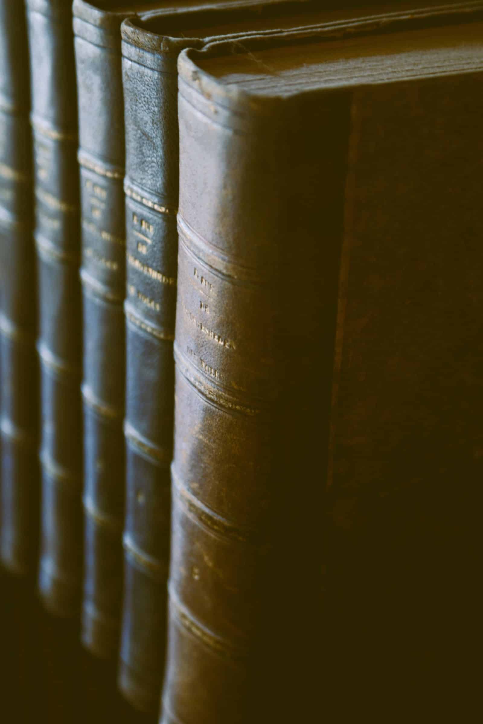 Rows of antique leather-bound law reports on a shelf