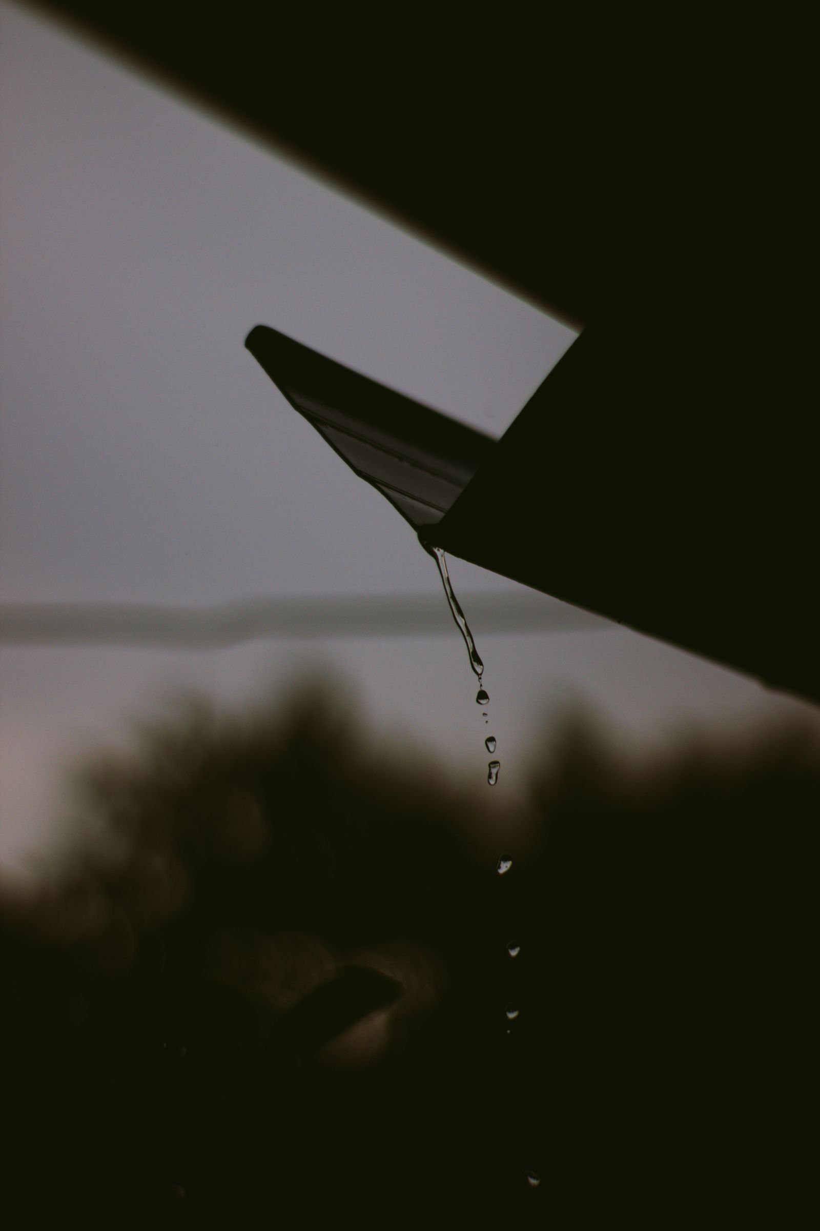 Water pouring off a roof in heavy rain