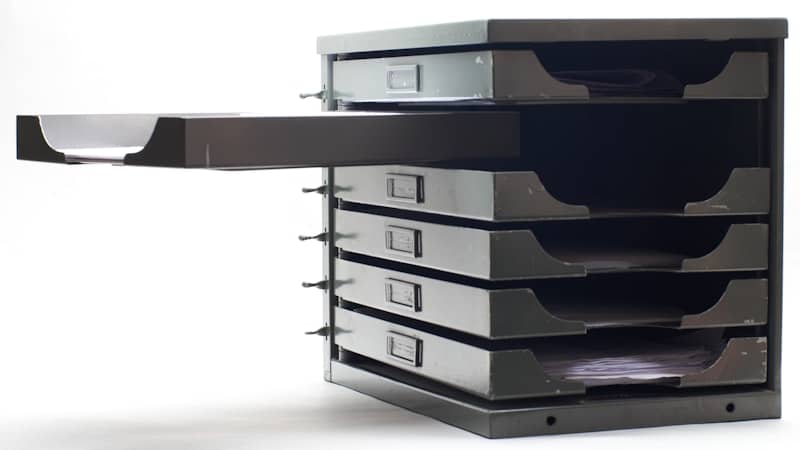 Stack of identical grey filing trays