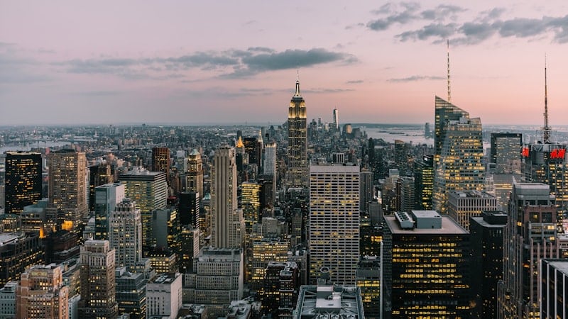 Aerial view of a dense city skyline at dusk