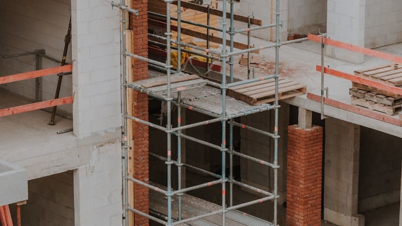 Concrete building under construction behind scaffolding