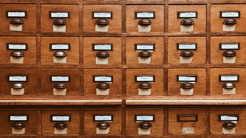 Wooden card catalogue with many small drawers