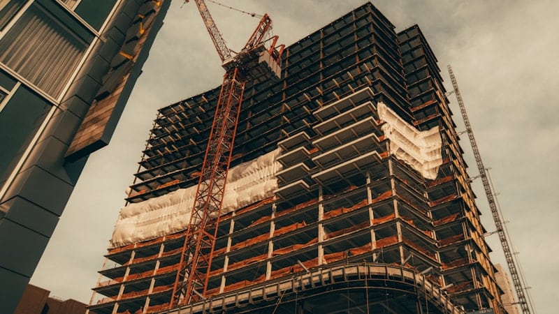 High rise building under construction with a crane