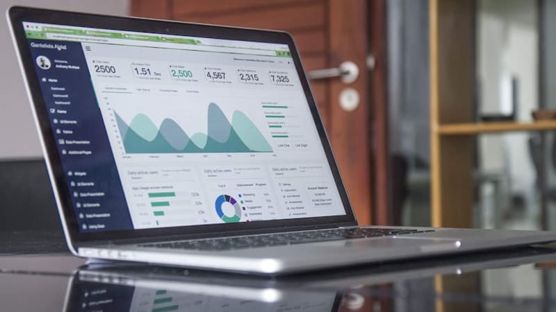 Laptop displaying a reporting dashboard on a desk