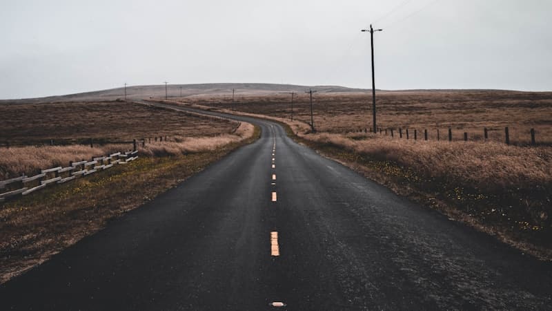 Empty road running through open countryside